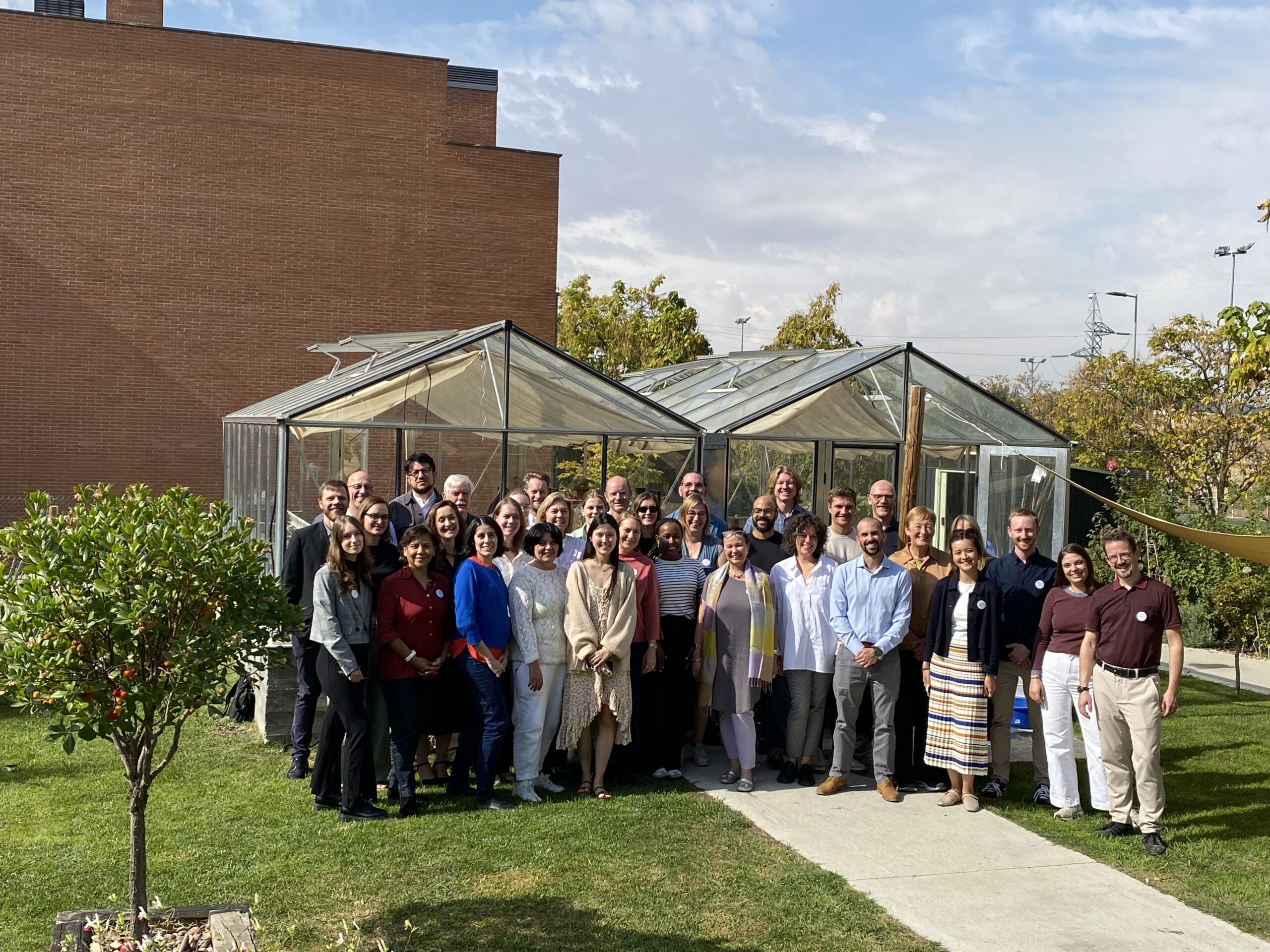DiCE Group Photo in front of a green house
